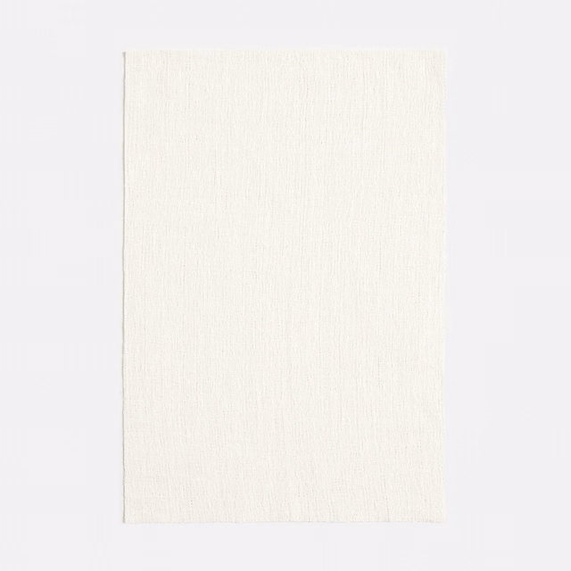 Soft ivory jacquard with fine vertical slub texture and delicate tonal variation