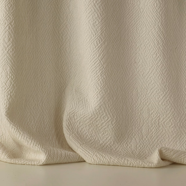 Warm Mastice beige jacquard with fine irregular texture in softly folded fabric