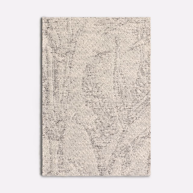 Pale graphite jacquard swatch with mottled abstract flecks and fine woven texture