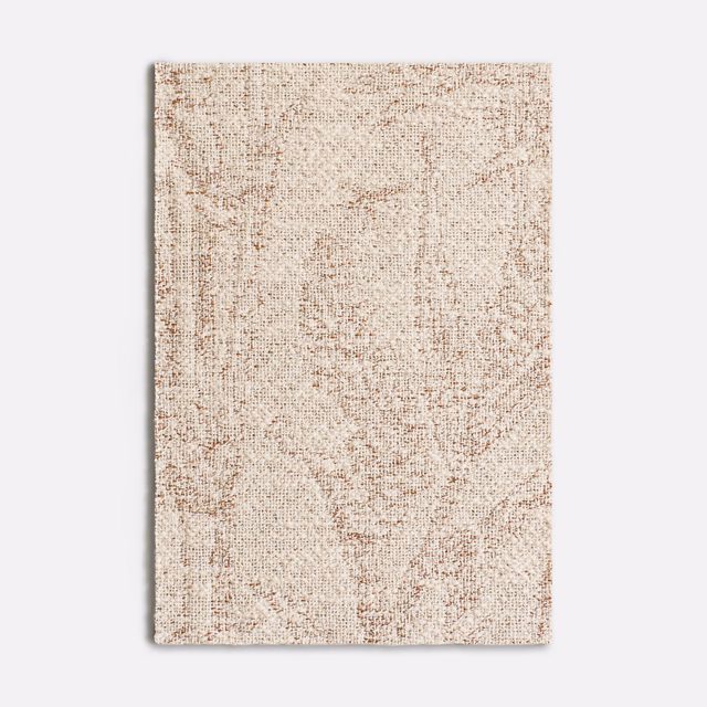 Warm cream jacquard with rust-red flecks and softly distressed woven tracery