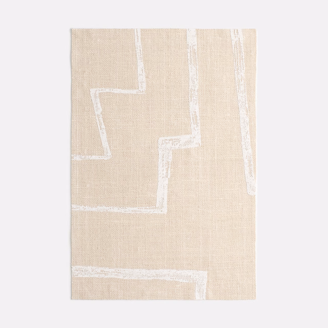 Warm caolino beige textile with chalk-white stepped geometric lines and fine woven texture