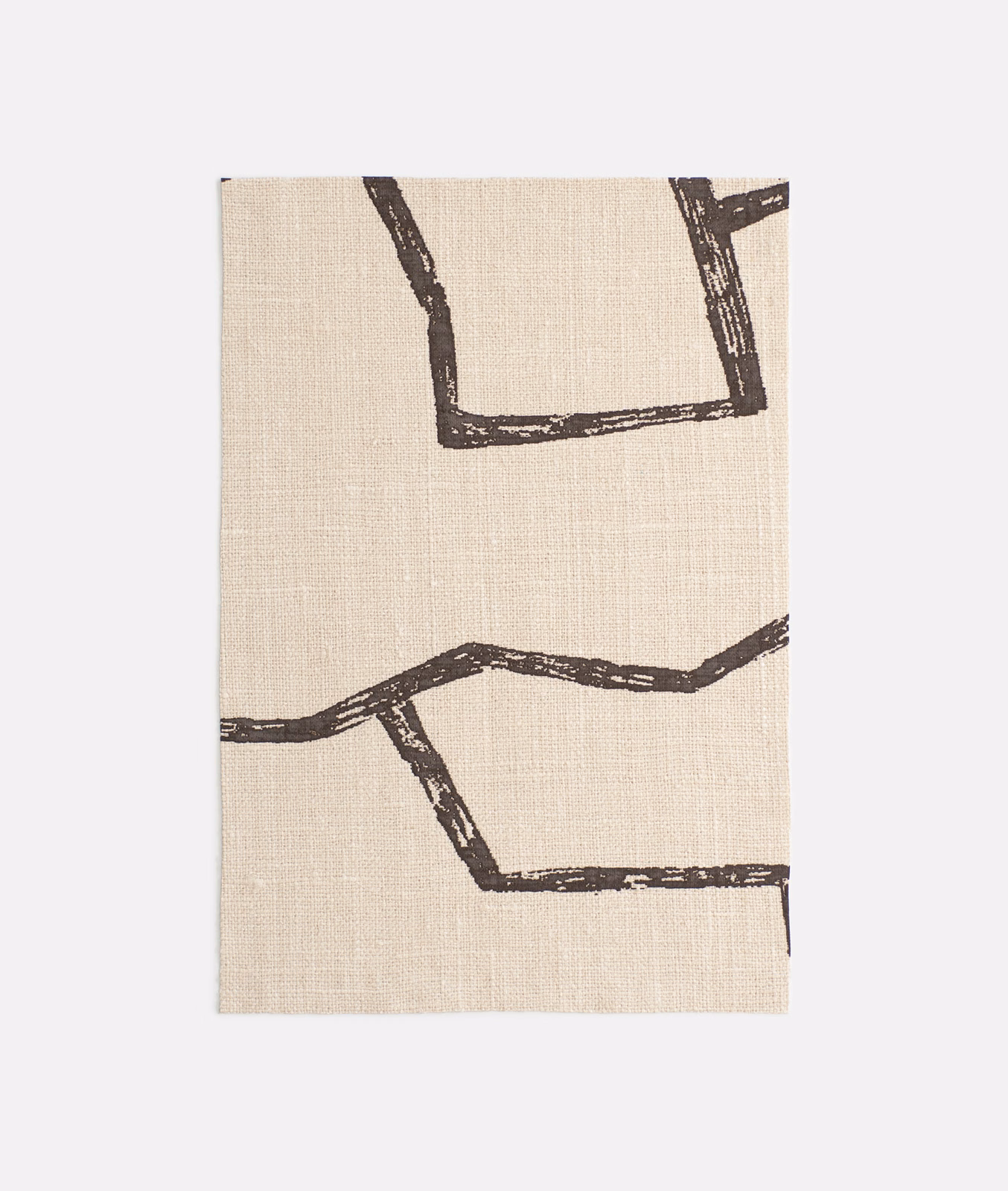 Warm beige fabric with distressed dark brown geometric outline motifs and visible woven texture