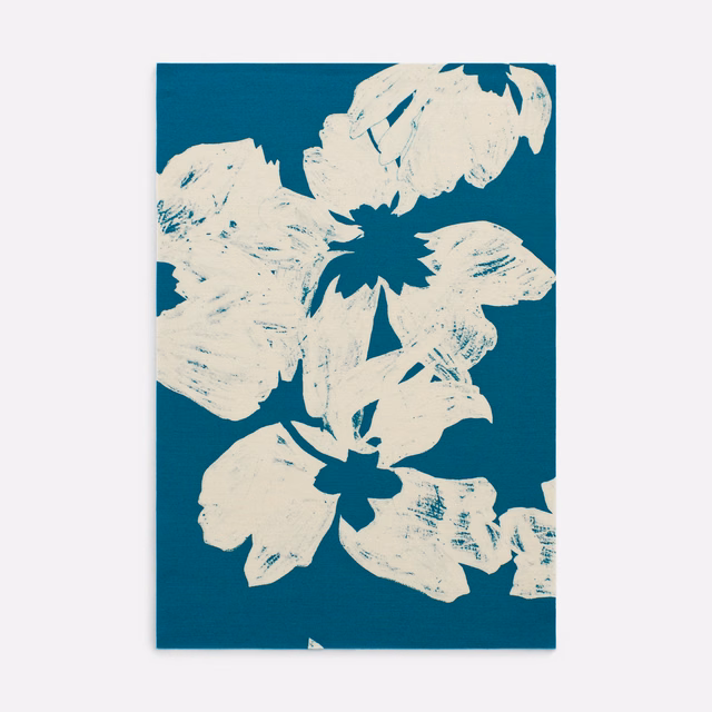 Deep teal fabric with oversized ivory flowers and expressive printed brush marks
