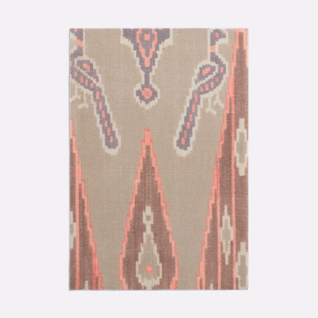 Warm taupe textile with coral, charcoal and cream stepped Persian geometric motifs