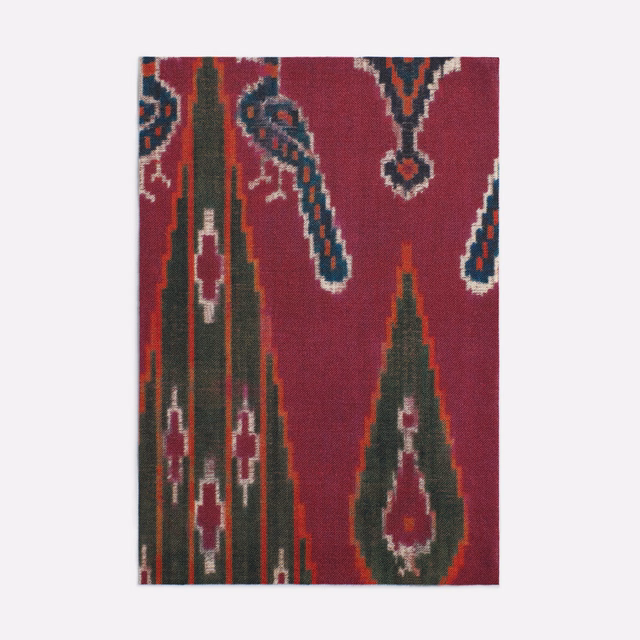Deep burgundy printed textile with green, teal and cream Persian motifs