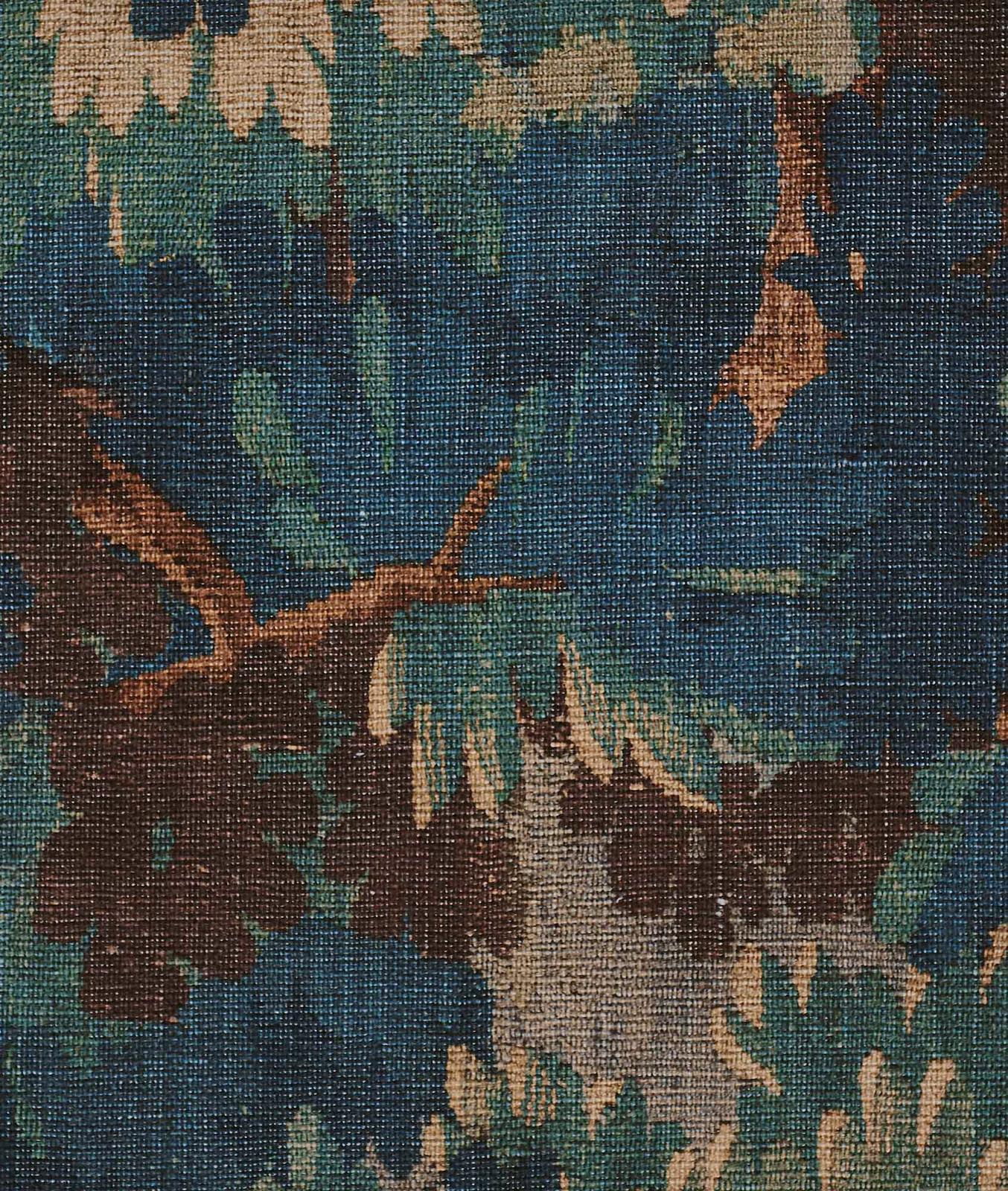 Coarse woven fabric with deep blue-green woodland print, brown branches and ochre foliage