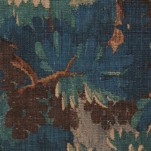 Coarse woven fabric with deep blue-green woodland print, brown branches and ochre foliage