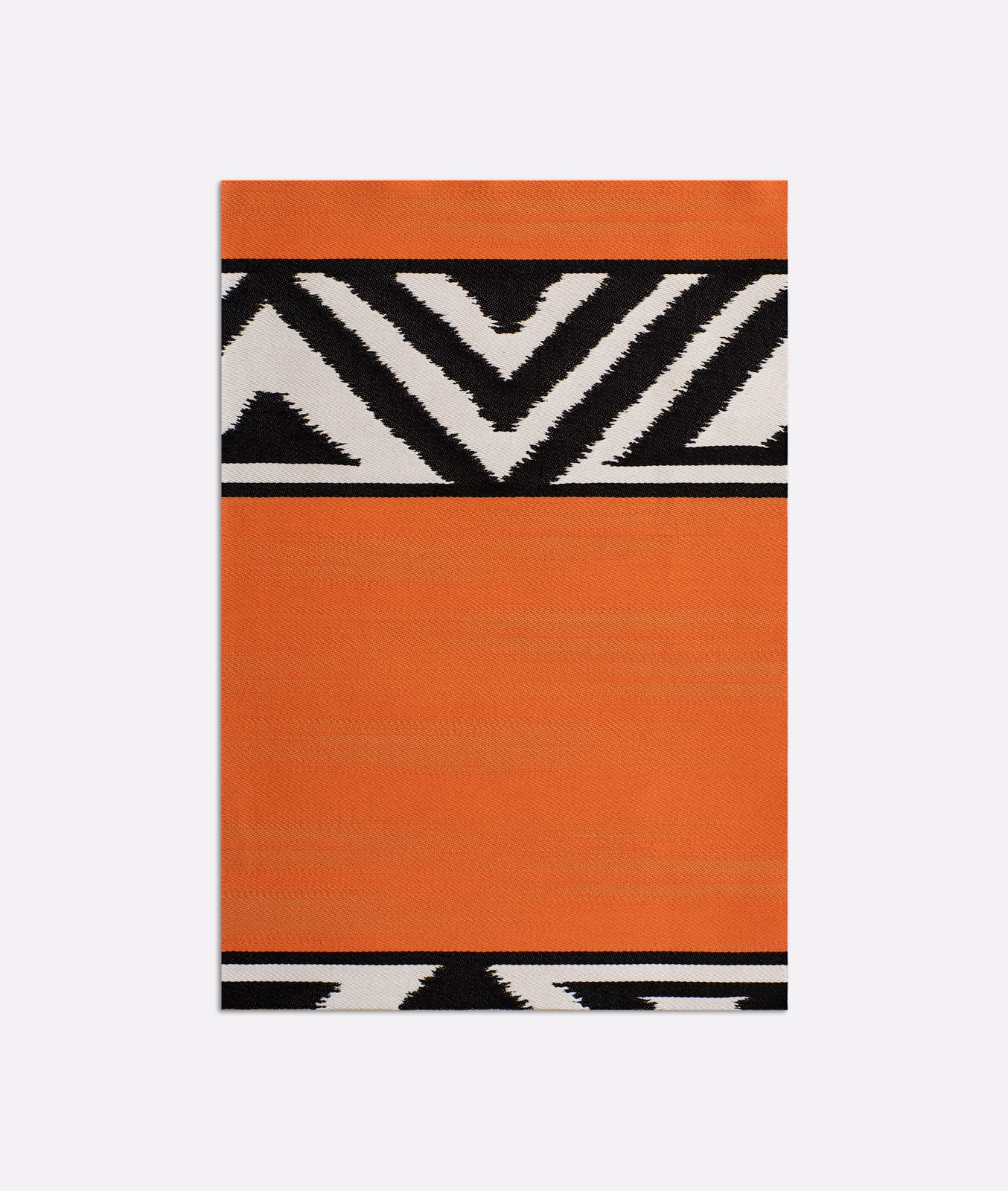 Burnt orange fabric with black and ivory chevron bands and fine woven texture
