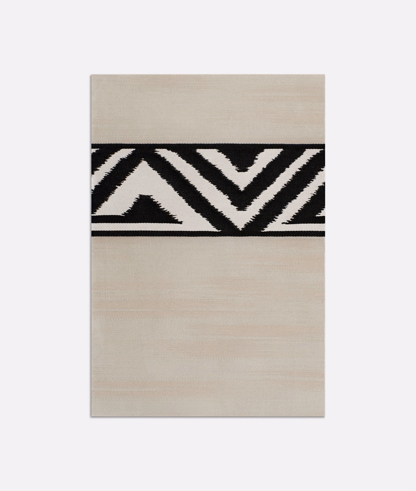 Pale pearl-beige satin with bold black zigzags and subtle horizontal sheen