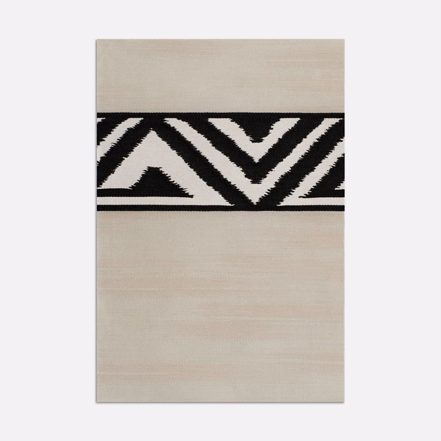 Pale pearl-beige satin with bold black zigzags and subtle horizontal sheen