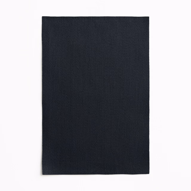 Deep blue-black satin with fine vertical grain and a restrained surface sheen