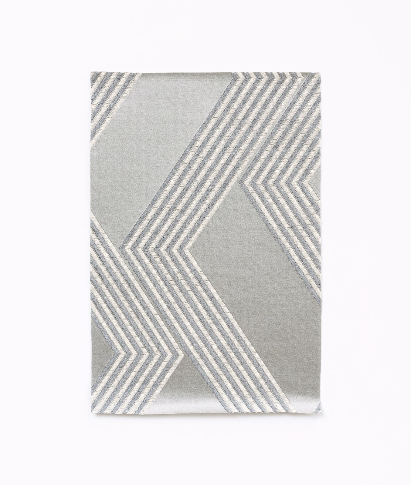 Icy silver-grey satin swatch with large white and grey angular chevron stripes