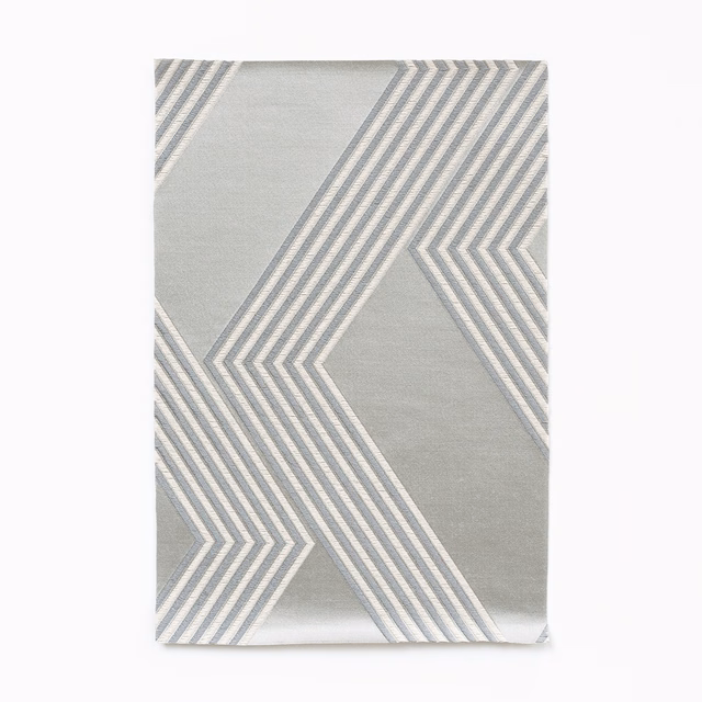 Icy silver-grey satin swatch with large white and grey angular chevron stripes