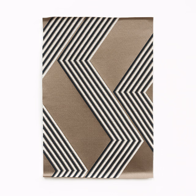 Warm taupe fabric with bold charcoal, black and ivory angular chevron stripes