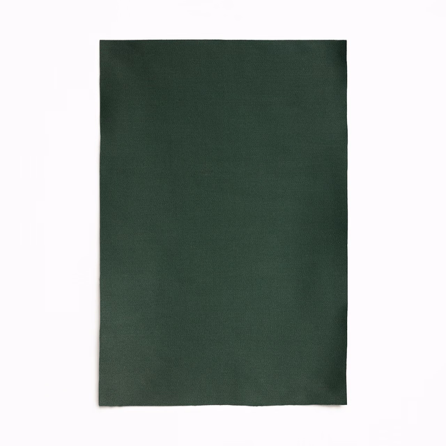 Deep forest-green satin swatch with a quiet sheen and fine woven texture