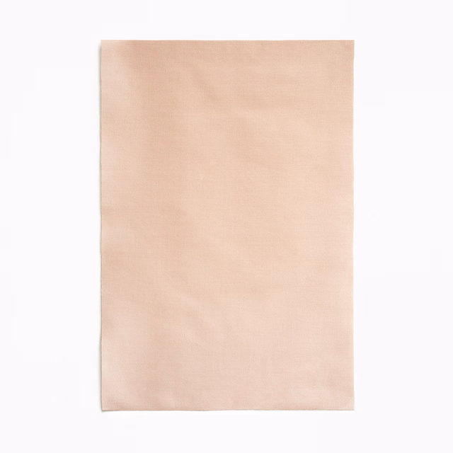 Pale nude-pink satin swatch with a soft, even surface sheen