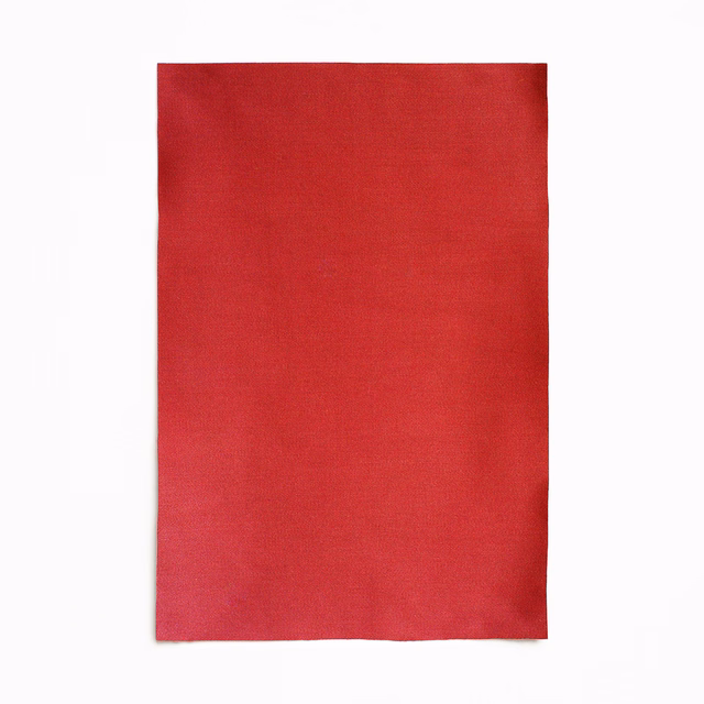 Close-up of rich crimson-red satin with a smooth, subtly lustrous plain weave