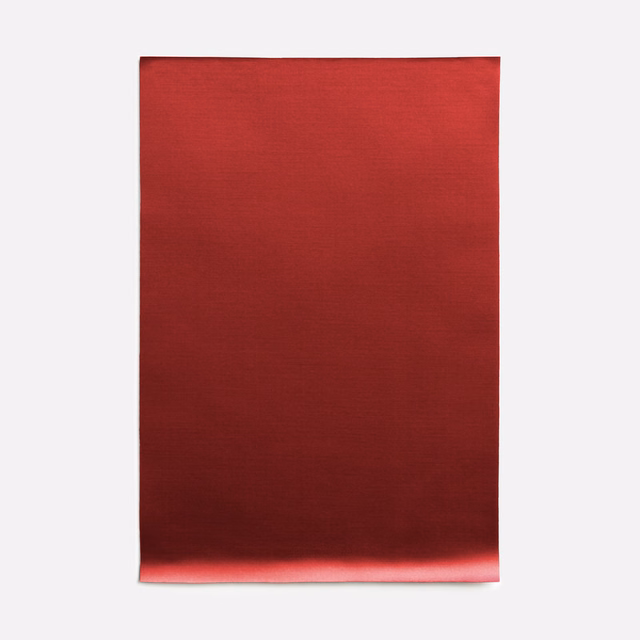 Deep ruby-red satin with fine horizontal grain and a soft reflected sheen