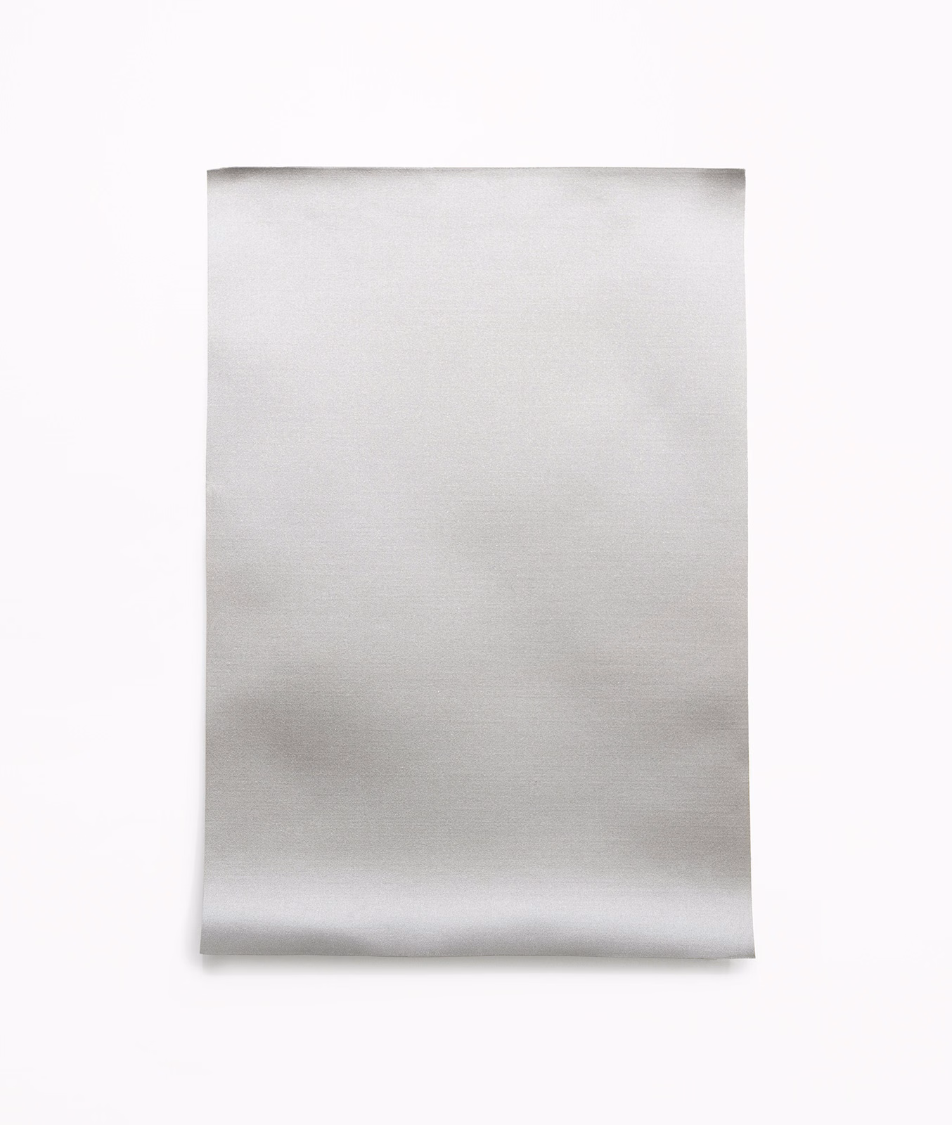 Pale pearl-grey satin swatch with soft horizontal sheen and curled lower edge