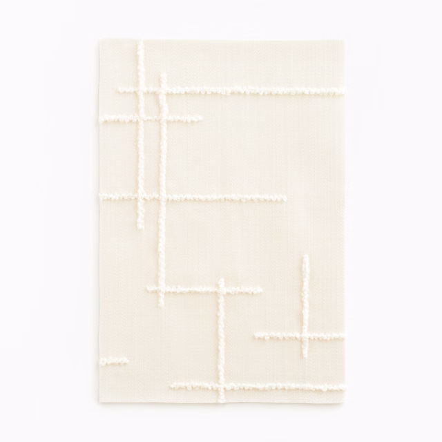 Pale magnolia satin ground with raised ivory broken-line geometric tracery