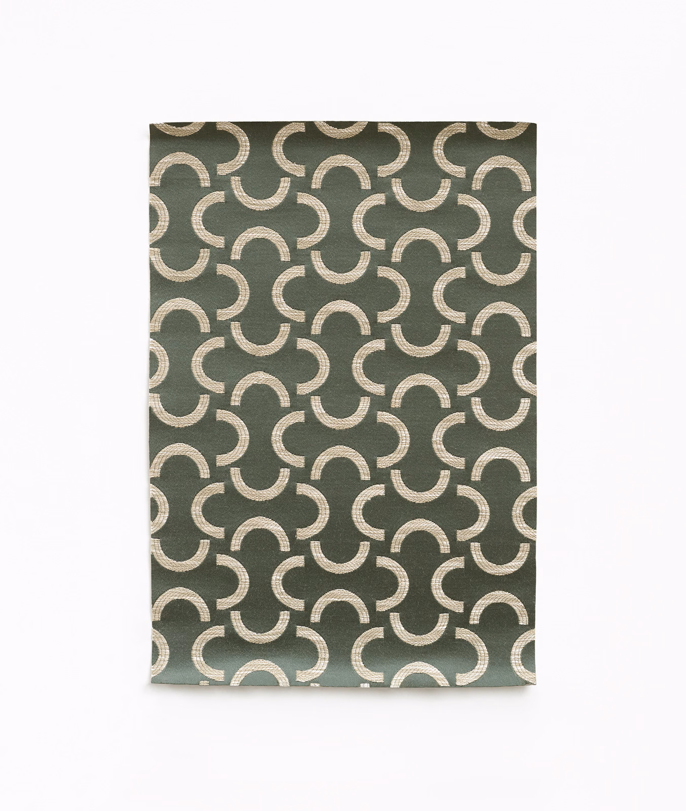 Muted olive-green woven fabric with pale interlocking crescent motifs