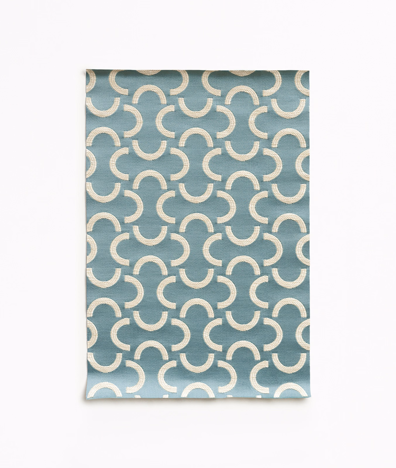 Angel blue satin with repeating ivory crescent arcs and a soft sheen