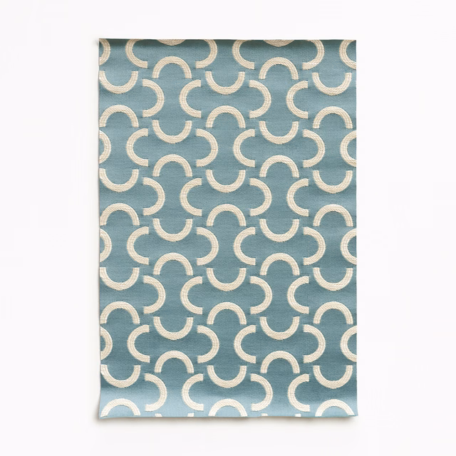 Angel blue satin with repeating ivory crescent arcs and a soft sheen