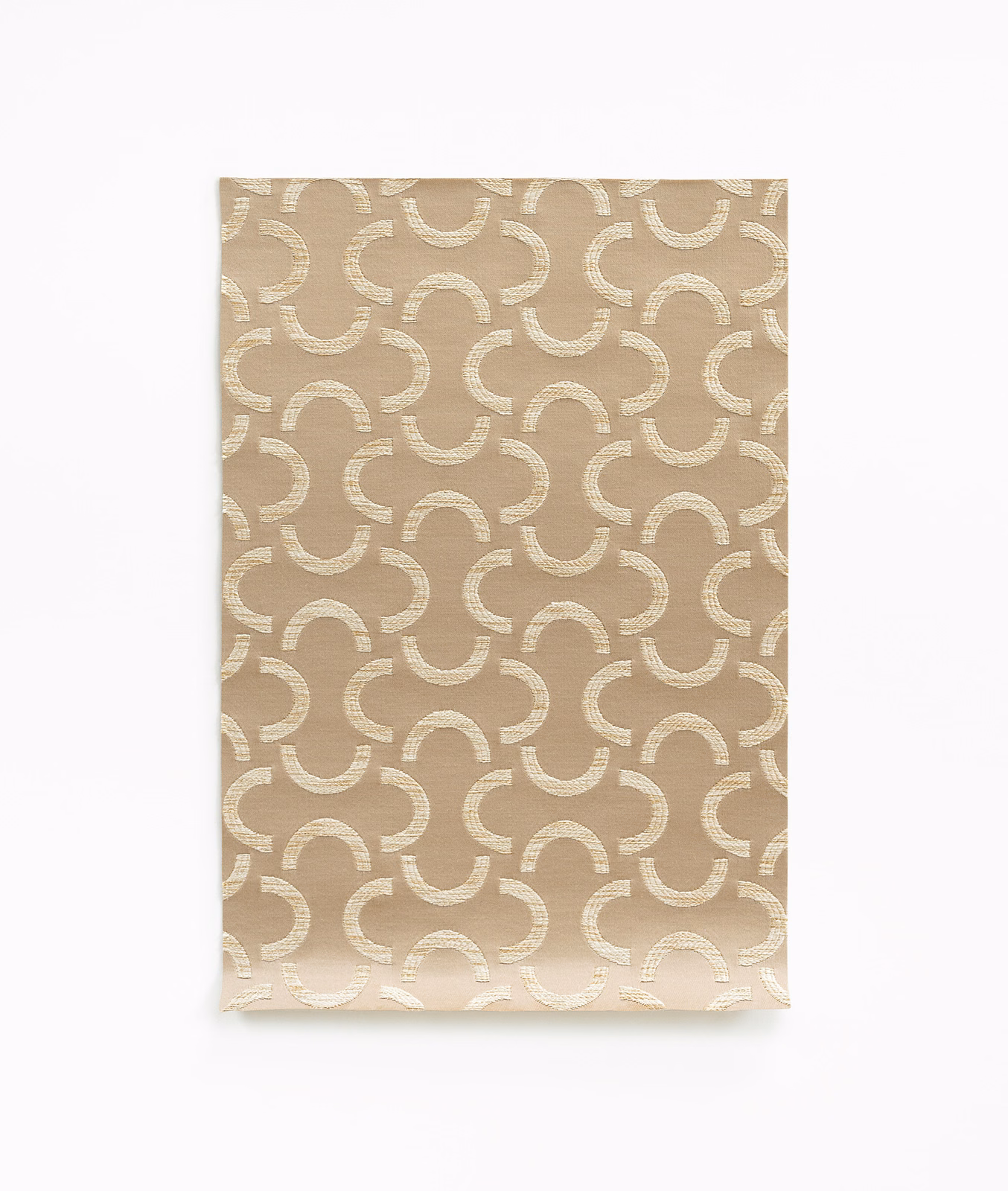 Warm beige satin swatch with repeating ivory curved arcs and subtle woven sheen