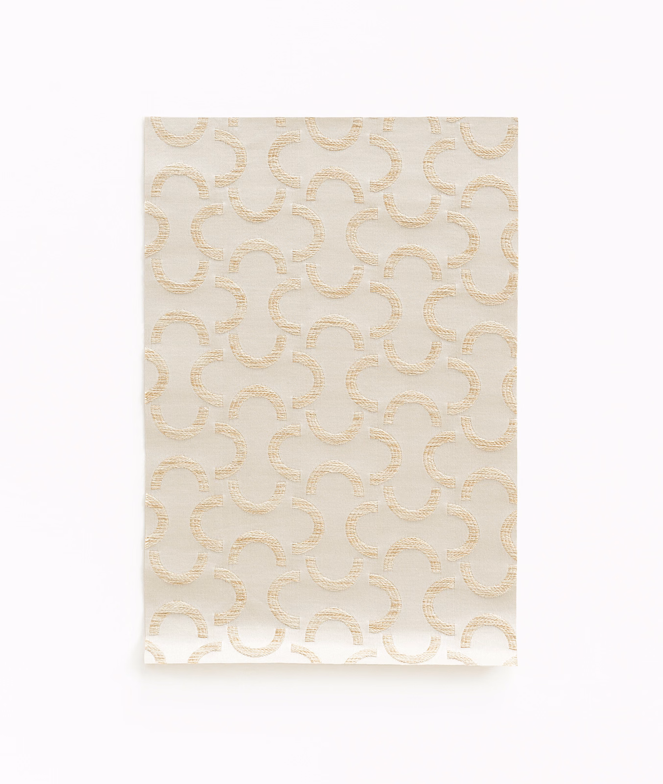 Warm ivory satin with pale champagne interlocking curves and subtle woven sheen