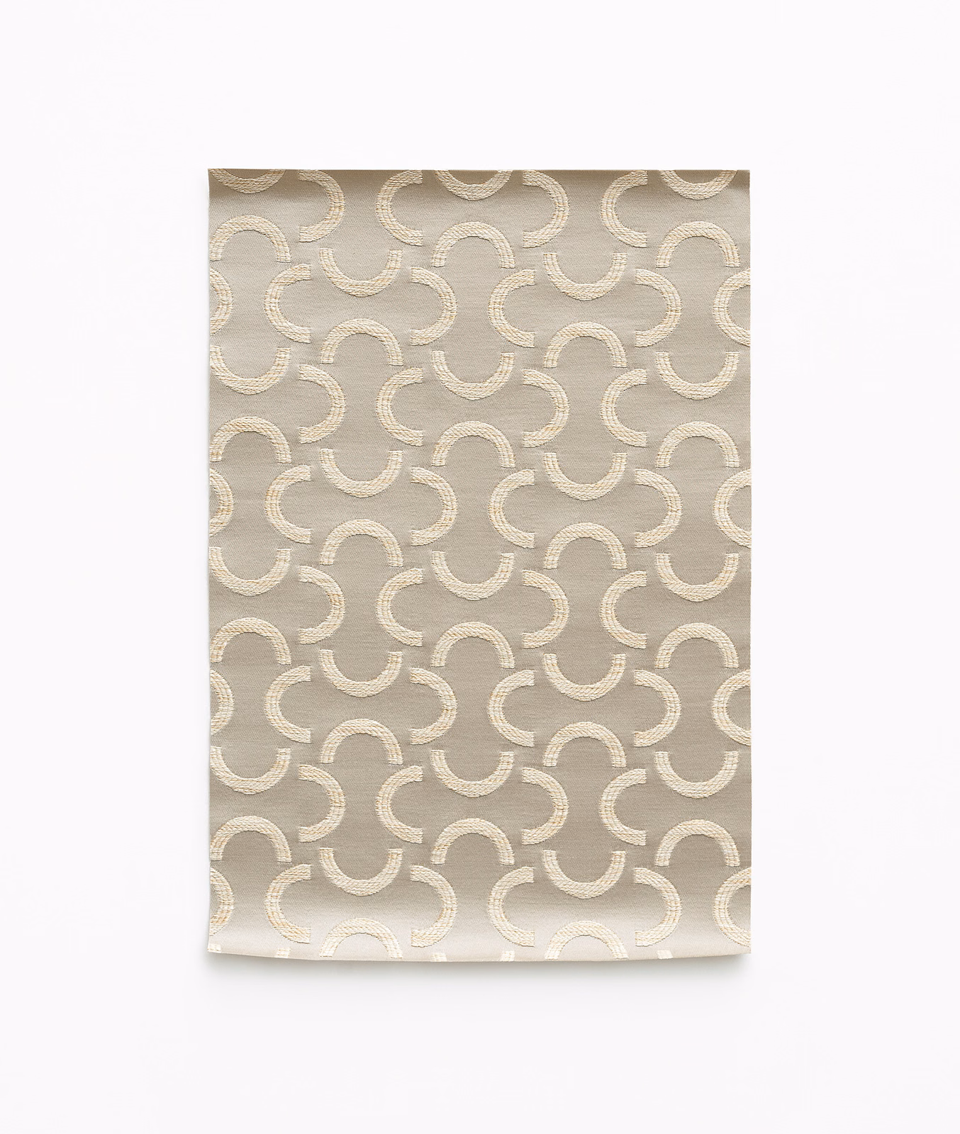 Warm taupe satin with cream interlocking curved motifs and subtle sheen