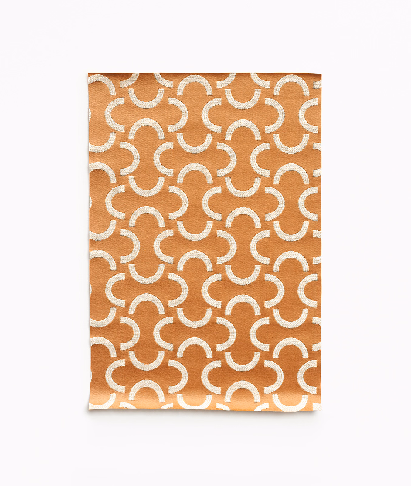 Warm melon-orange satin with repeating cream broken arcs and a subtle sheen