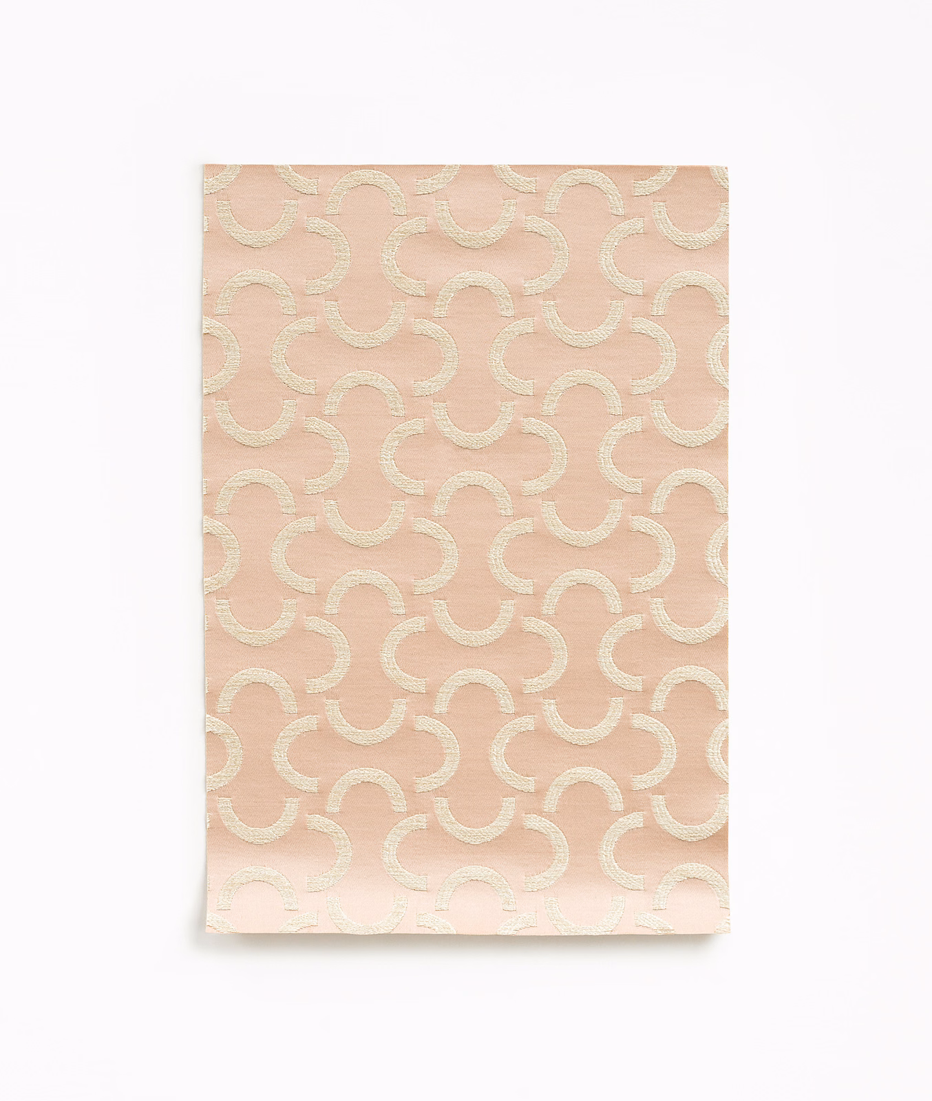 Dusty rose satin with ivory looping arcs and a soft surface sheen