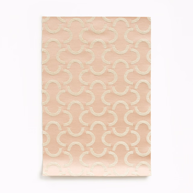 Dusty rose satin with ivory looping arcs and a soft surface sheen