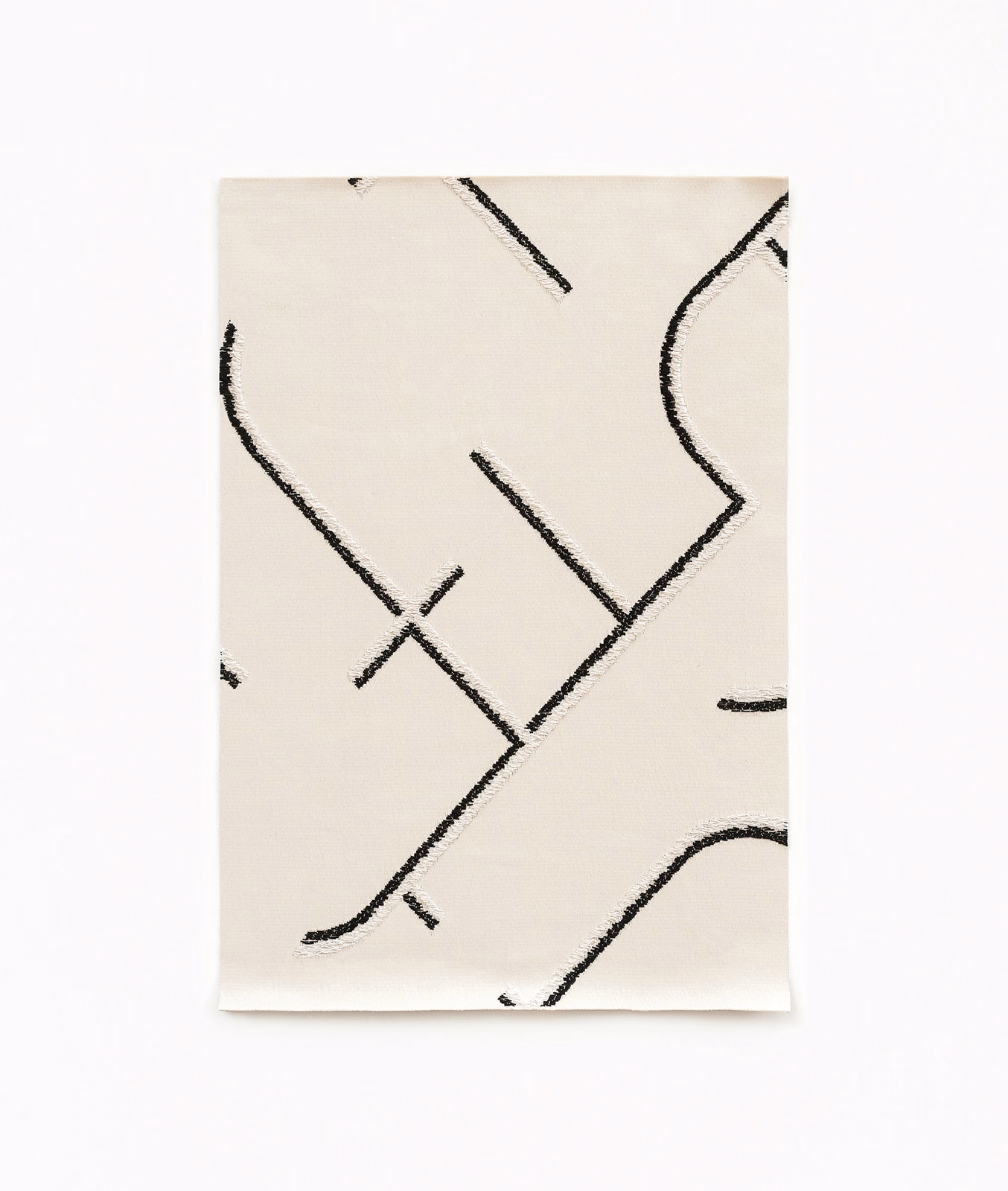 Ivory satin swatch with sweeping black abstract lines and subtle surface sheen