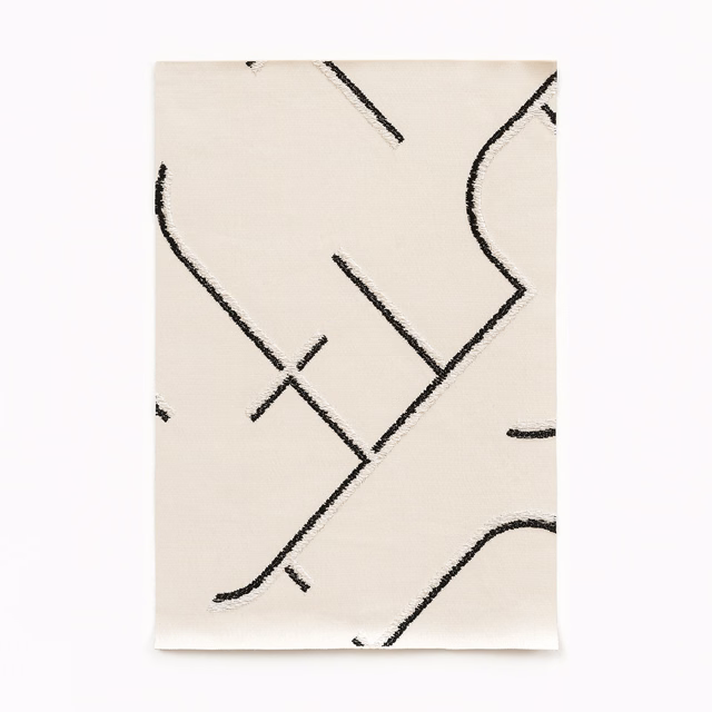Ivory satin swatch with sweeping black abstract lines and subtle surface sheen