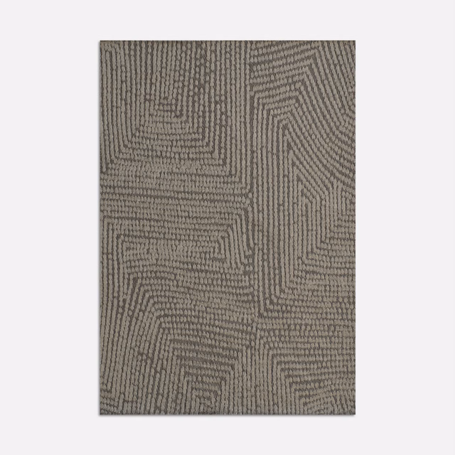 Muted taupe woven textile with raised maze-like geometric lines and charcoal shadowing