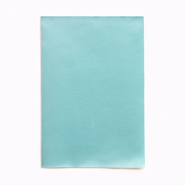 Pale aqua-teal satin surface with subtle directional sheen