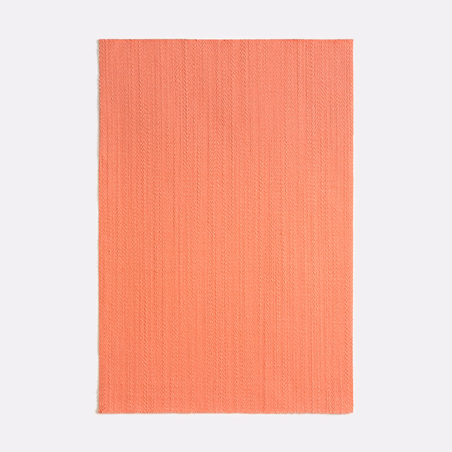 Warm coral satin swatch with fine vertical ribs and a soft sheen