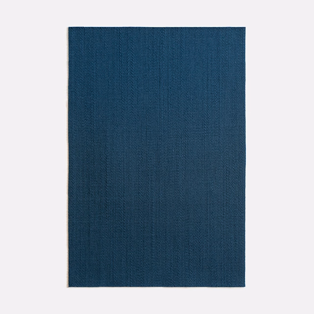 Deep marine-blue satin with subtle vertical woven texture in close-up