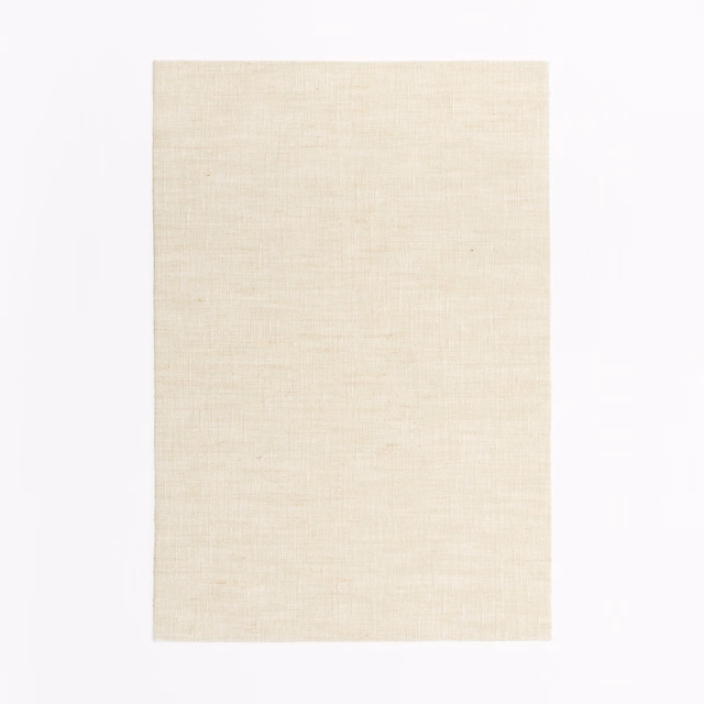 Warm ivory Acquerello Sand swatch with fine, softly irregular sand-toned woven texture