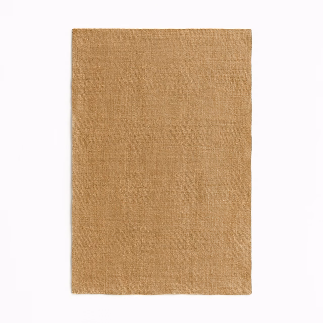 Warm ochre-tan sheer fabric with a fine, subtly irregular plain weave