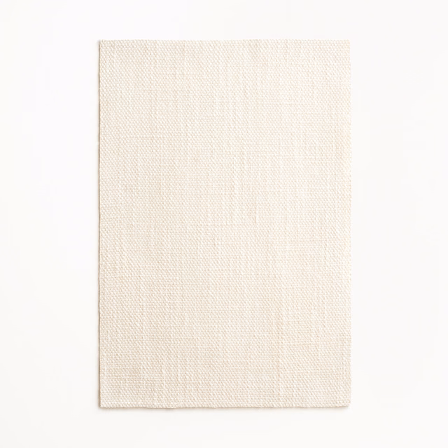 Warm ivory sheer fabric swatch with a fine, subtly vertical woven texture
