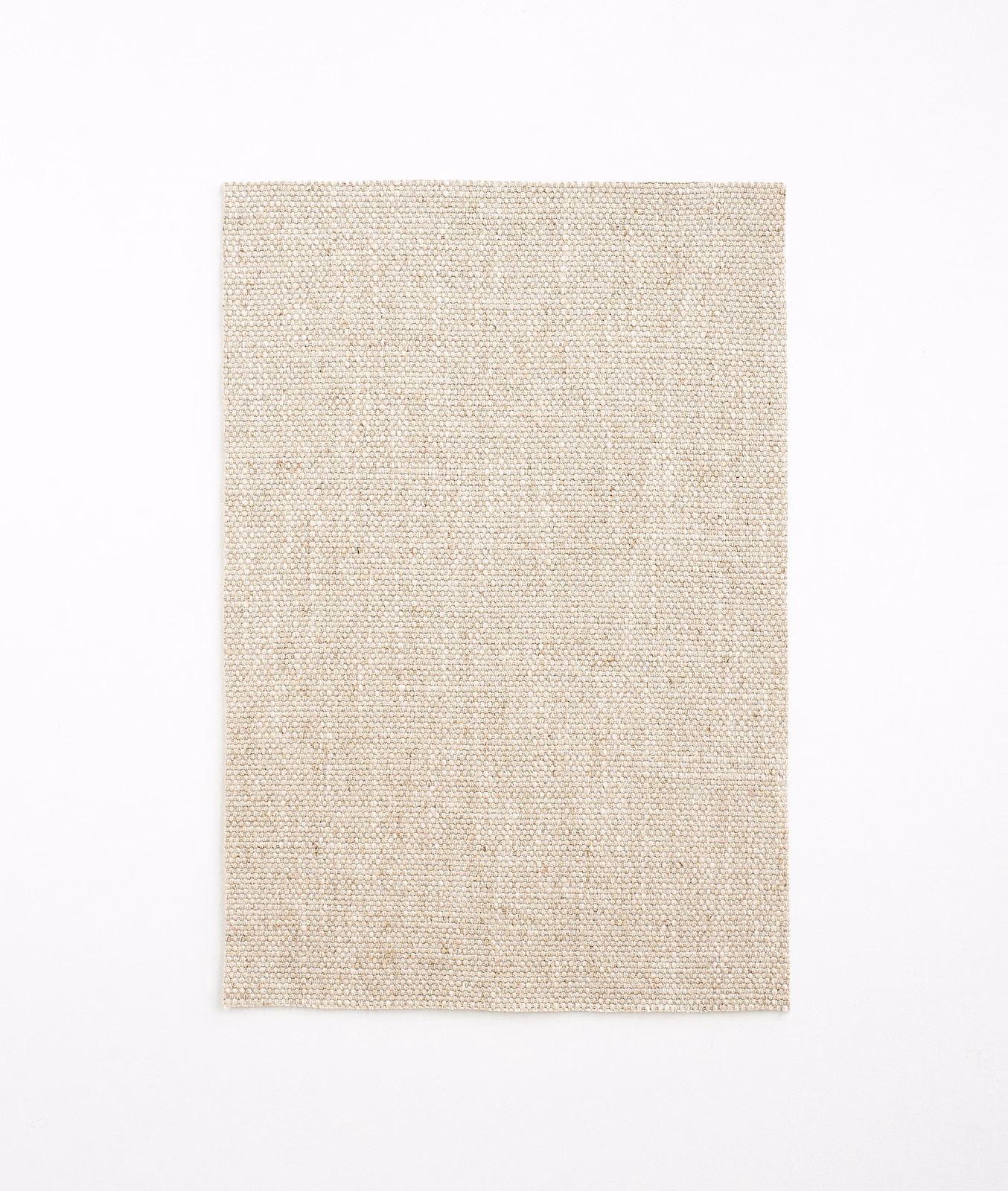 Close-up of pale natural-beige plain weave with subtle linen-like flecks