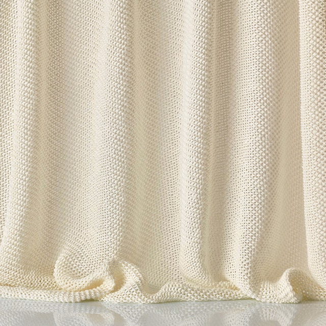 Warm ivory-cream sheer mesh with vertical folds and a softly rippled hem