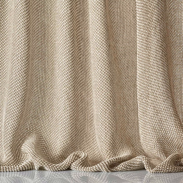 Warm beige sheer weave gathered into softly rippling curtain folds