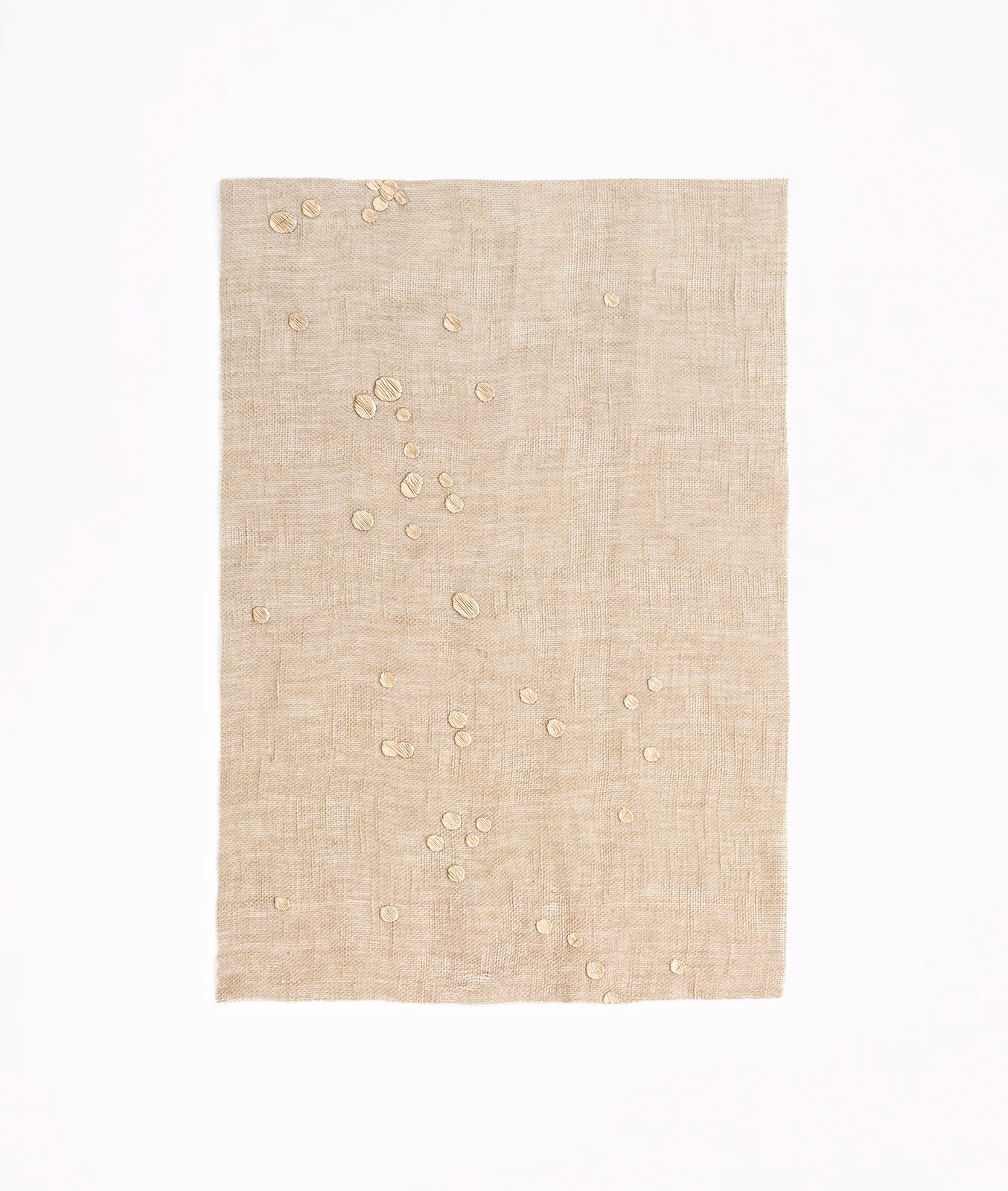 Sand-beige sheer ground with scattered raised circular confetti details and fine crossweave