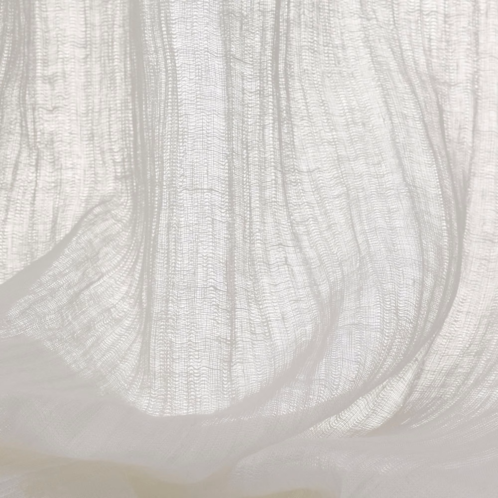 Pale ivory sheer fabric with open vertical weave gathered into translucent folds