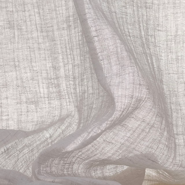 Pale pearl-grey sheer with open gauze weave gathered into translucent folds