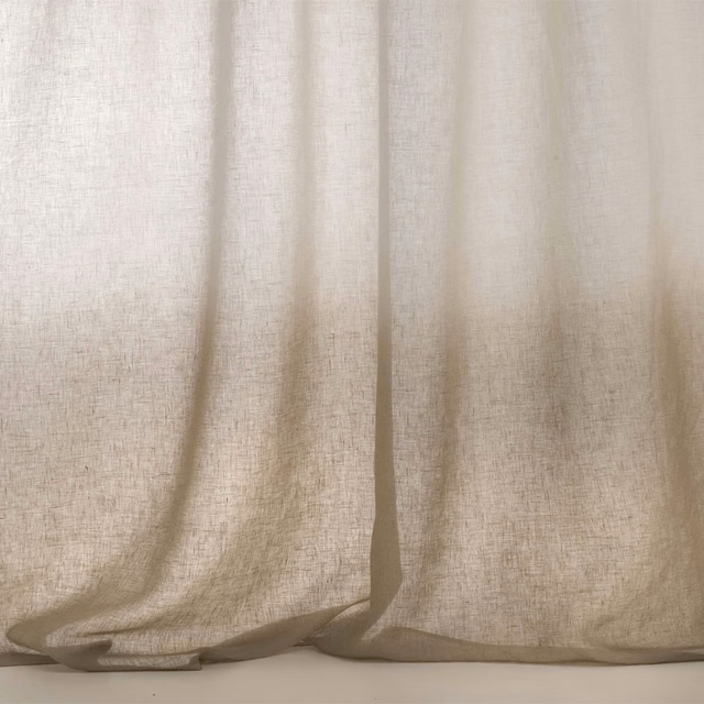 Warm ivory-beige sheer fabric with open weave and softly pooling curtain folds
