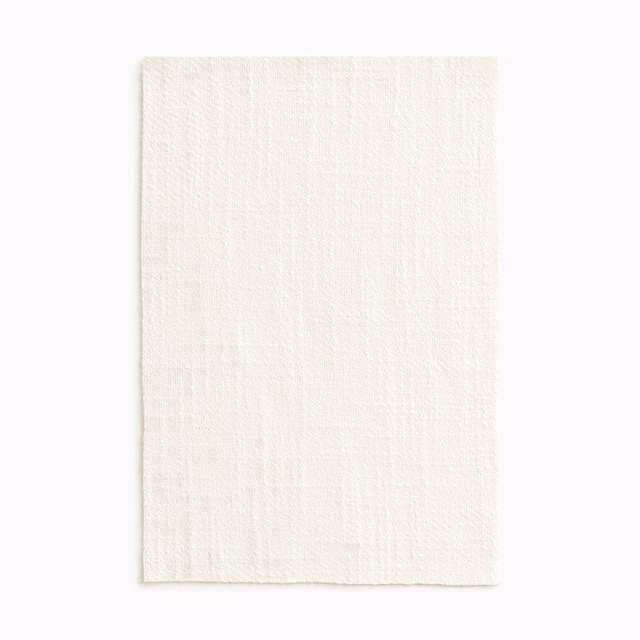 Ivory sheer fabric swatch with subtle vertical slub texture and softly woven surface